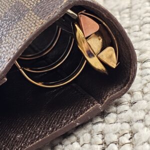 Gold-tone ring mechanism of the Louis Vuitton Damier Ebene agenda