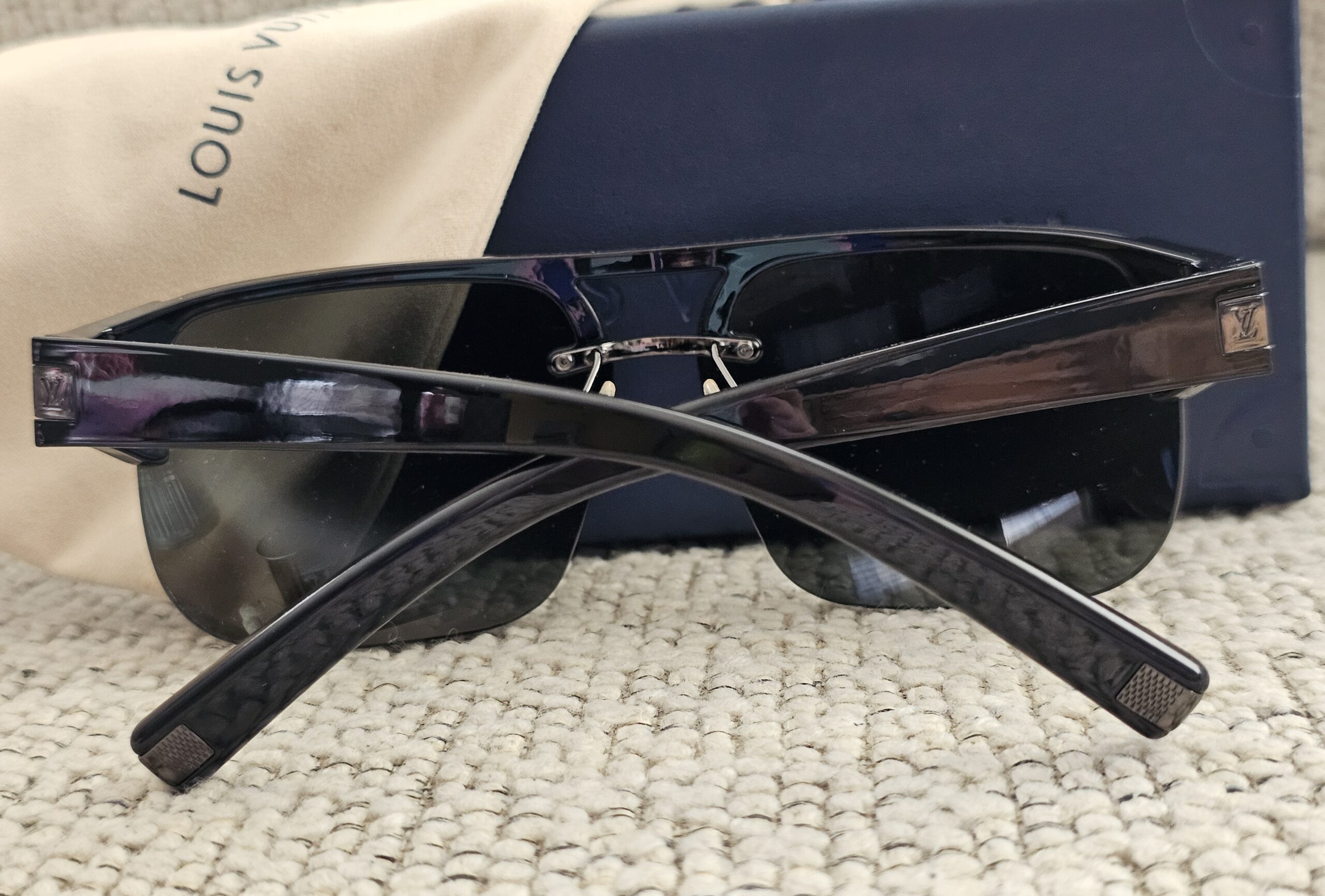 Side view of the black Louis Vuitton Z0527U sunglasses with the arms open