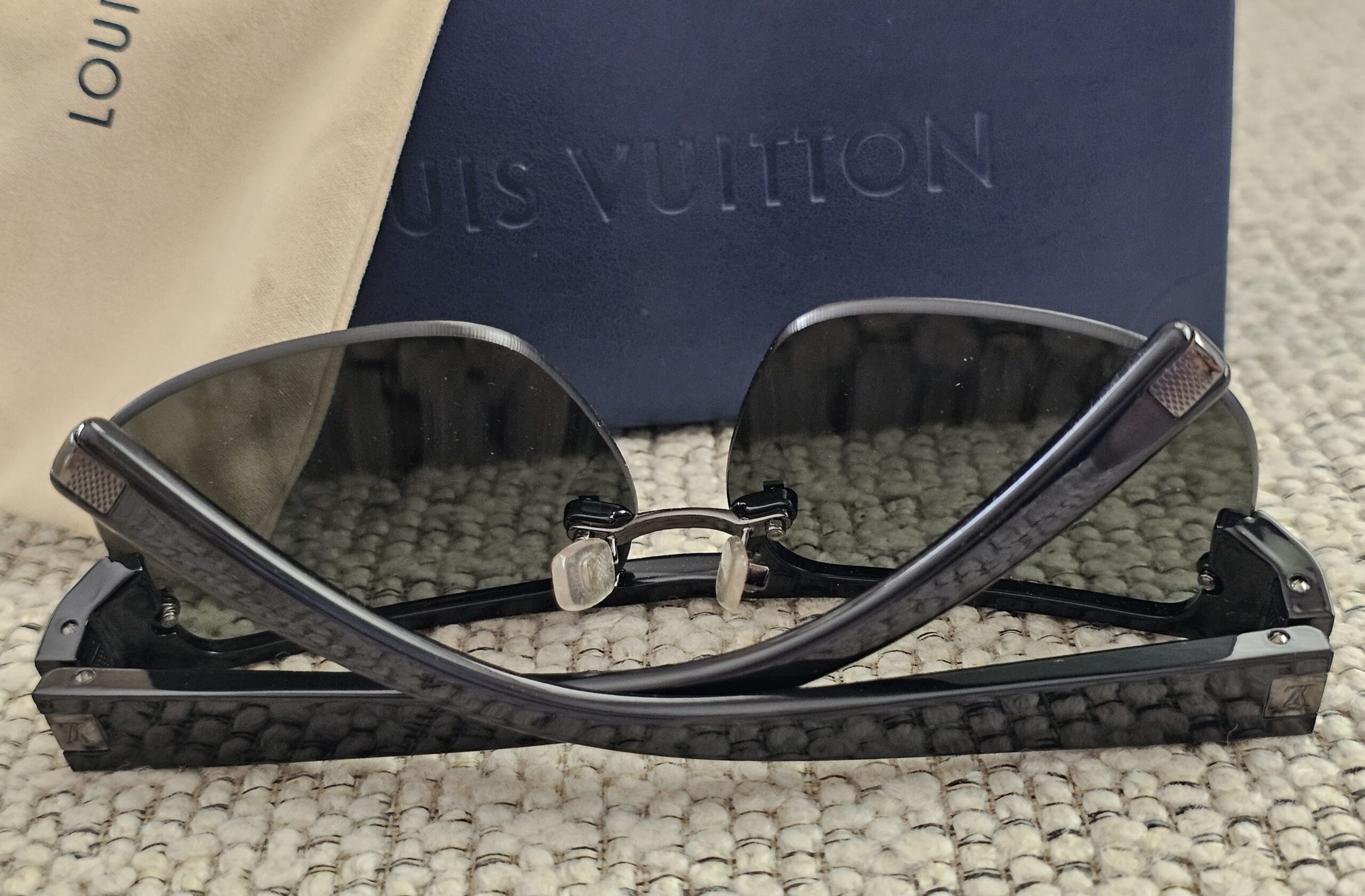 Louis Vuitton Z0527U shield sunglasses folded on the Louis Vuitton case
