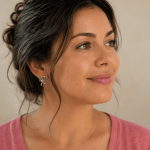 Illustrative model shot showing how four leaf clover stud earrings are worn, not a photo of the item for sale