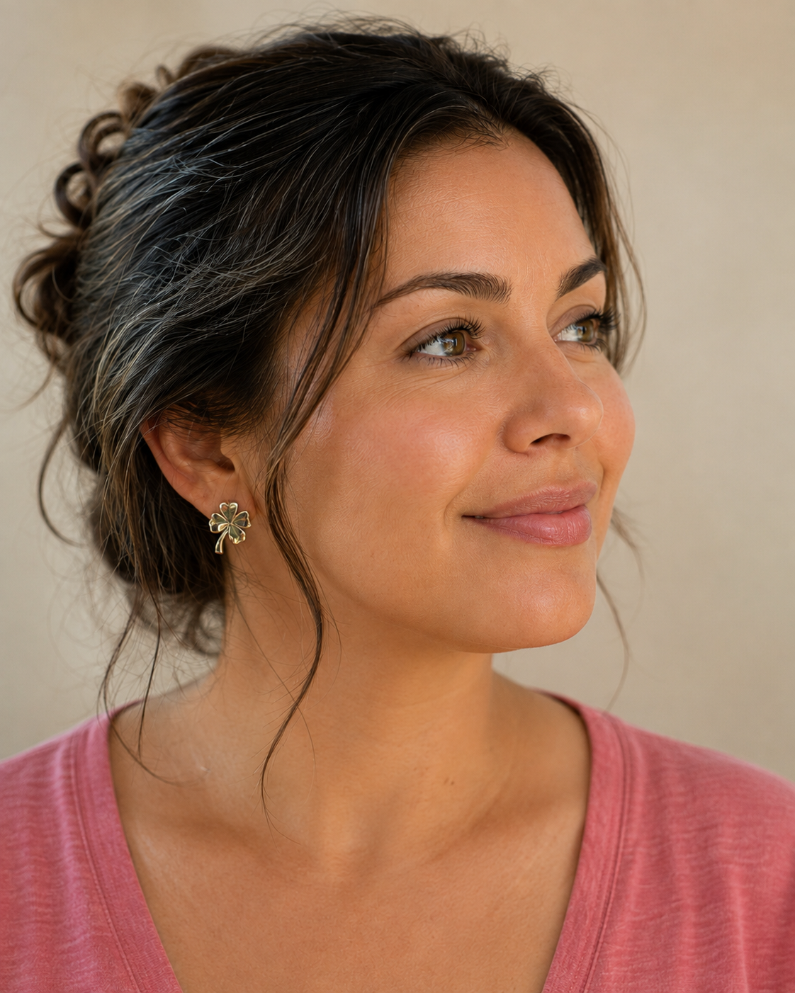Illustrative model shot showing how four leaf clover stud earrings are worn, not a photo of the item for sale