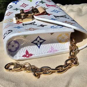 Side of the pouch with the gold-tone chain on the dust bag