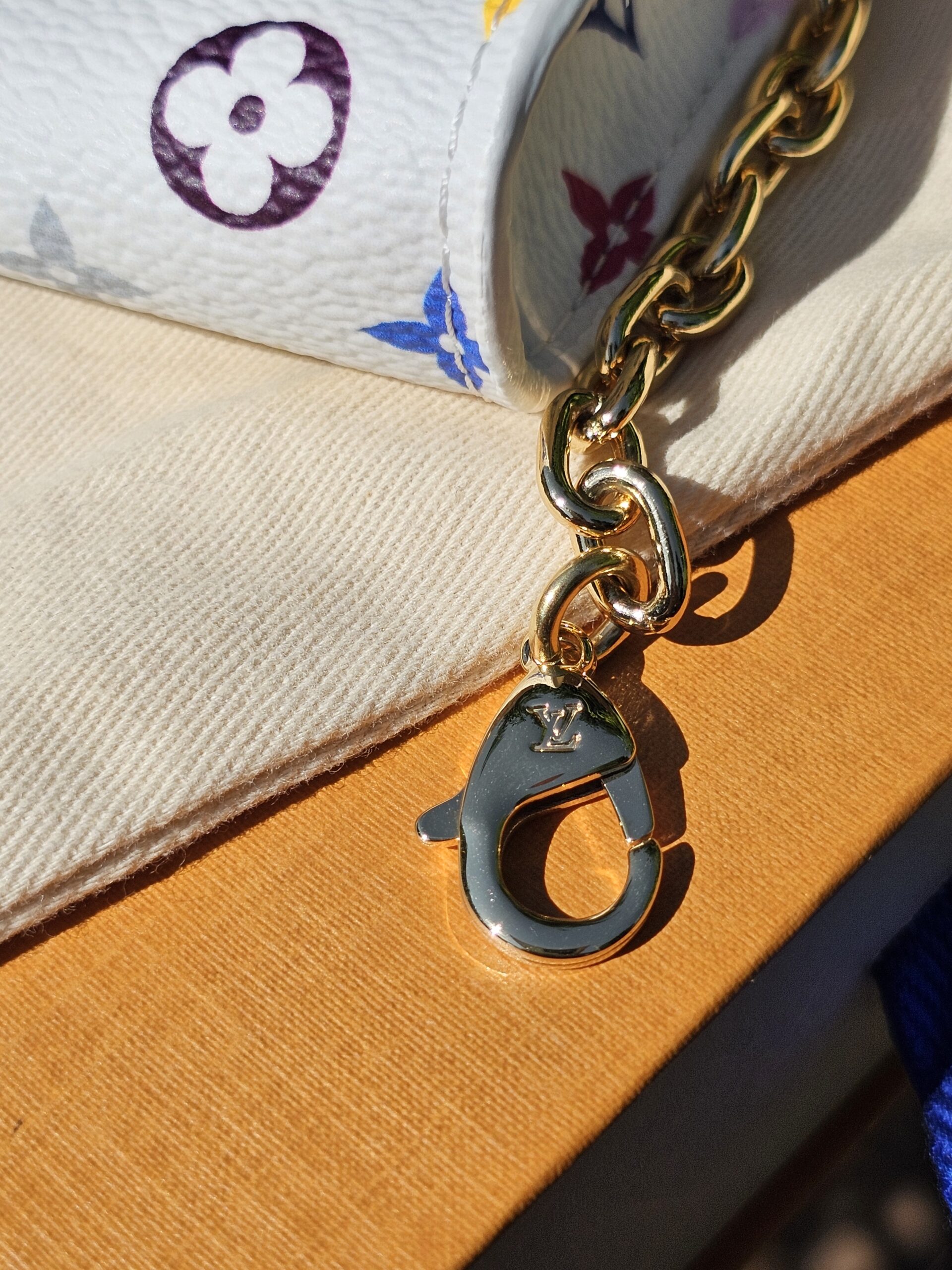 Gold-tone lobster clasp on the detachable chain