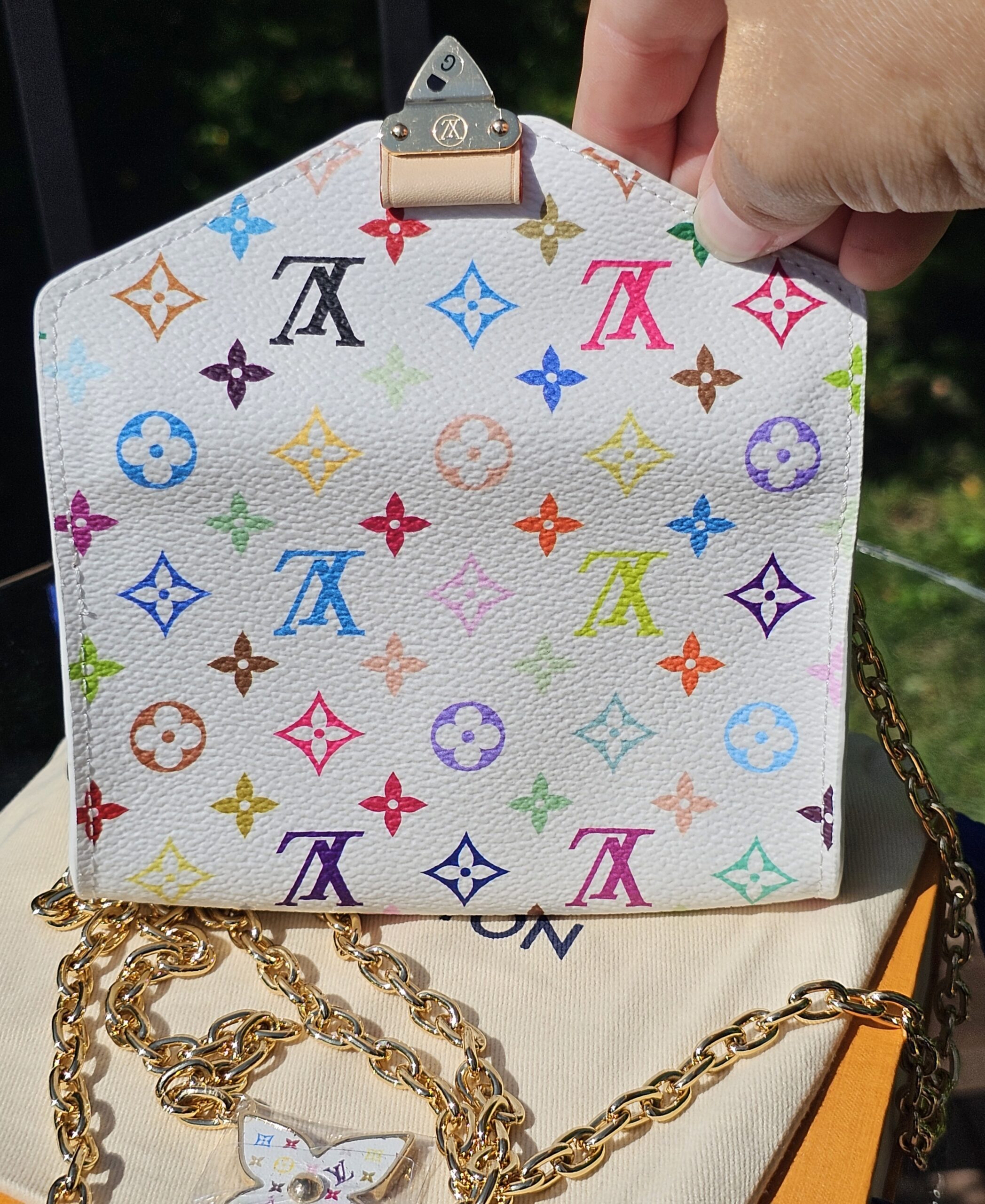 Pouch with the chain attached, flap slightly open