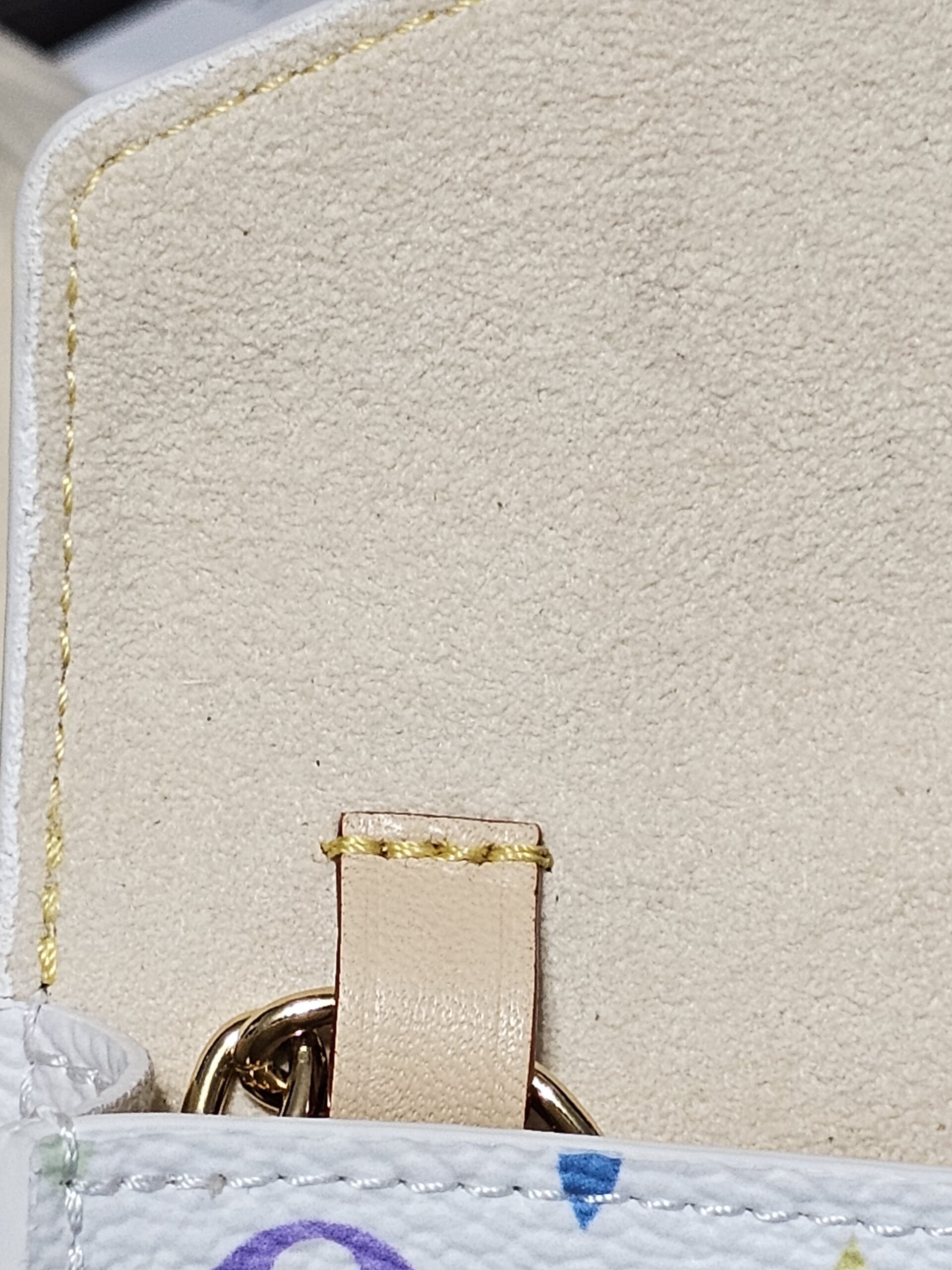 Interior vachetta tab inside the flap