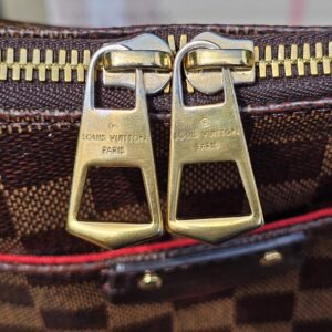Twin gold-tone Louis Vuitton Paris zip pulls on the South Bank Besace