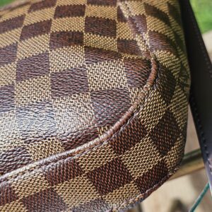 Close-up of the Damier Ebene coated canvas on the Louis Vuitton South Bank Besace