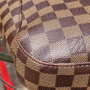 Corner of the Louis Vuitton South Bank Besace shown for condition