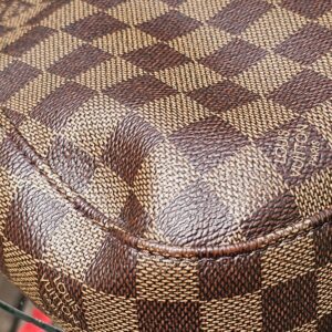 Seam and stitching on the Damier Ebene canvas of the Louis Vuitton South Bank Besace