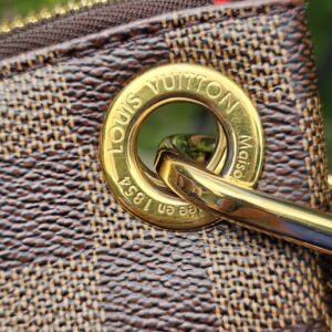 Gold-tone Louis Vuitton engraved ring hardware on the South Bank Besace