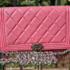 Chanel Boy long wallet in pink quilted leather shown with the aftermarket silver chain