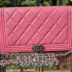 Chanel Boy long wallet in pink quilted leather shown with the aftermarket silver chain