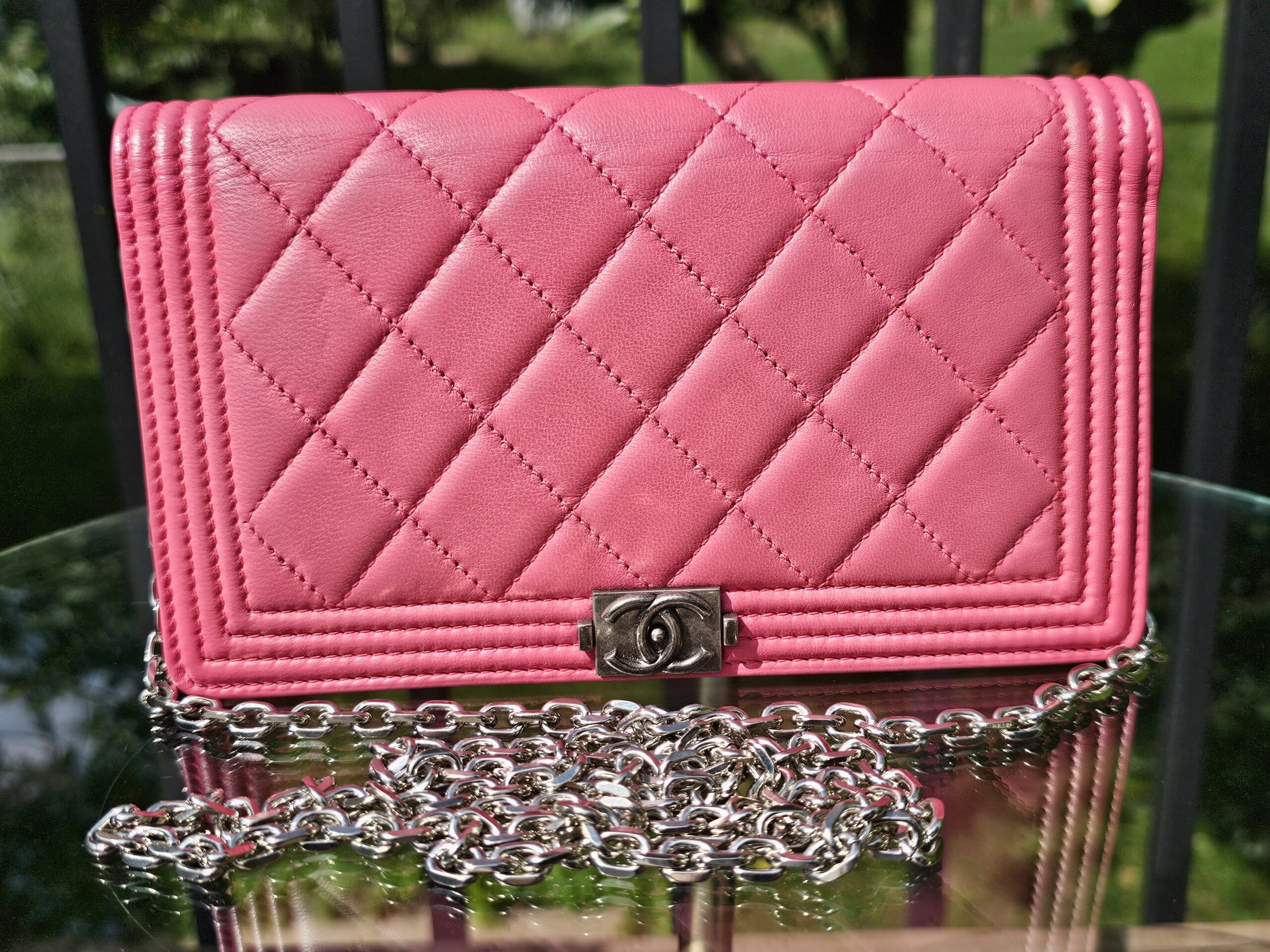 Chanel Boy long wallet in pink quilted leather shown with the aftermarket silver chain