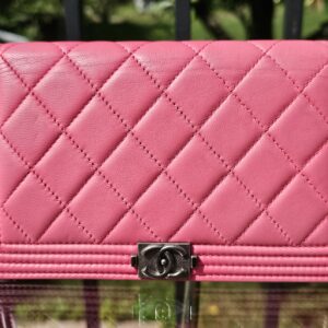 Front of the Chanel Boy long wallet in vibrant pink quilted leather with the ruthenium Boy CC clasp