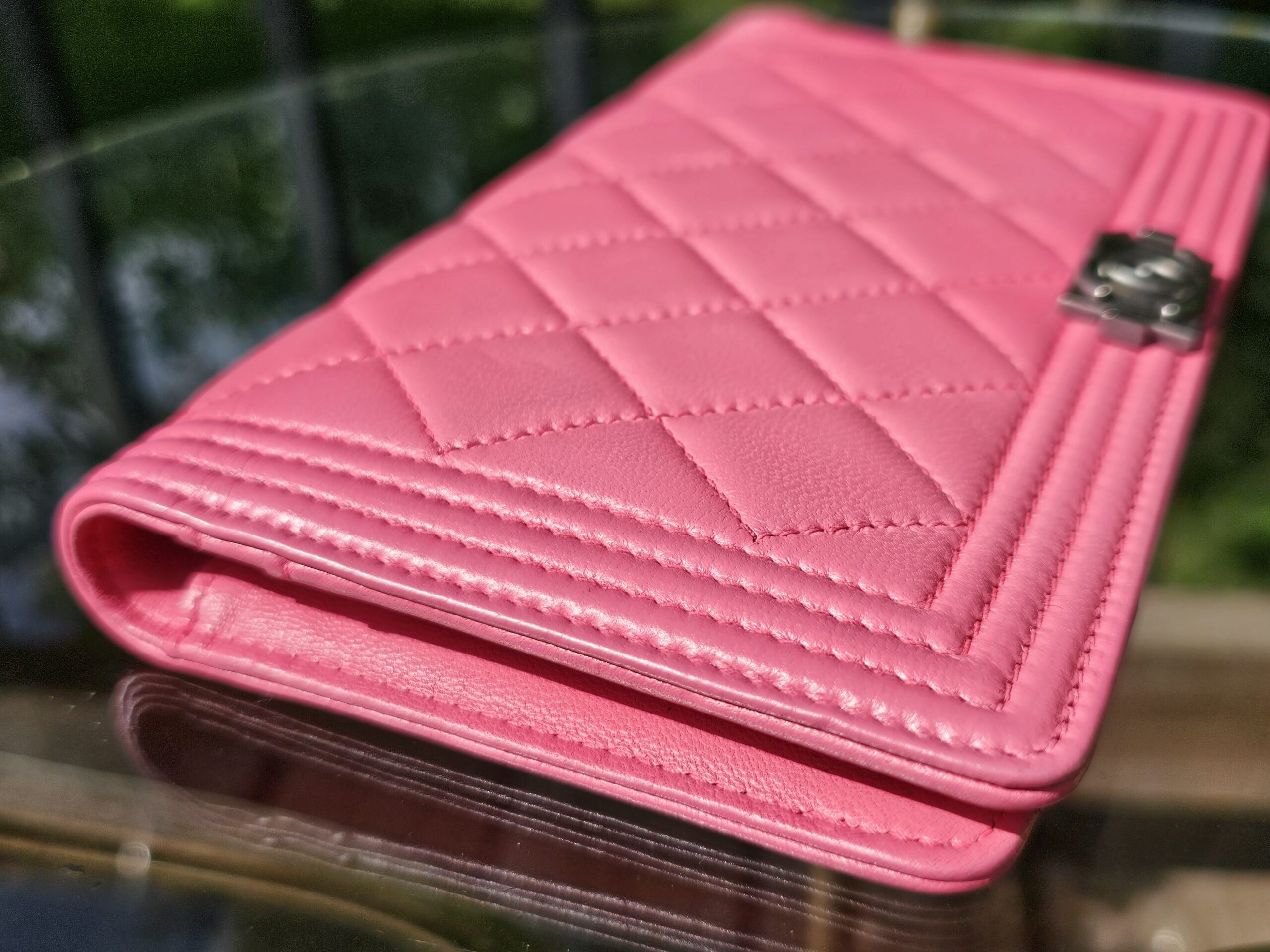 Side profile of the Chanel Boy long wallet showing the puffy quilted leather