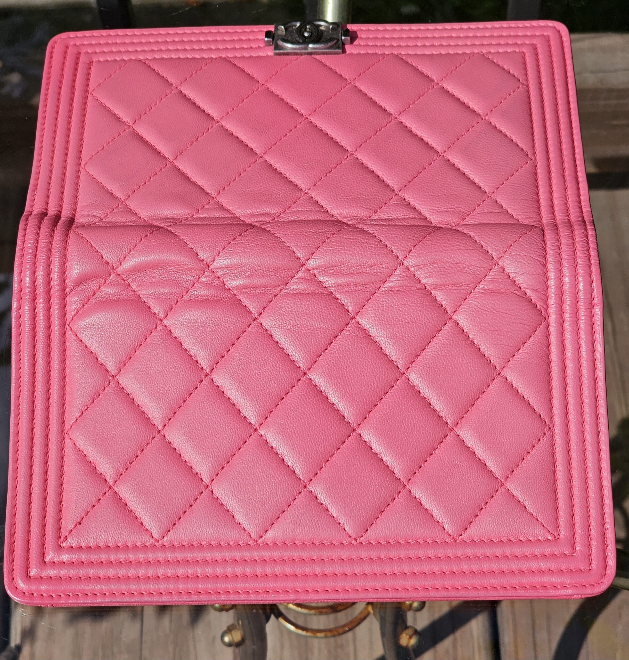 Quilted pink leather inside the flap of the Chanel Boy long wallet