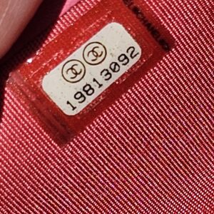 Chanel serial sticker reading 19813092 inside the pink Boy long wallet