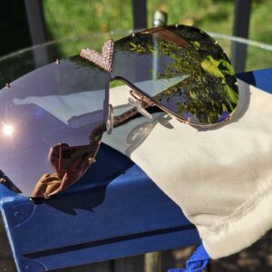 Louis Vuitton Z1060W LV Drive Sunglasses Rose Gold - resting on their dust pouch and blue box