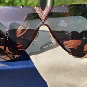 Gradient shield lenses of the rose gold-tone Louis Vuitton LV Drive sunglasses
