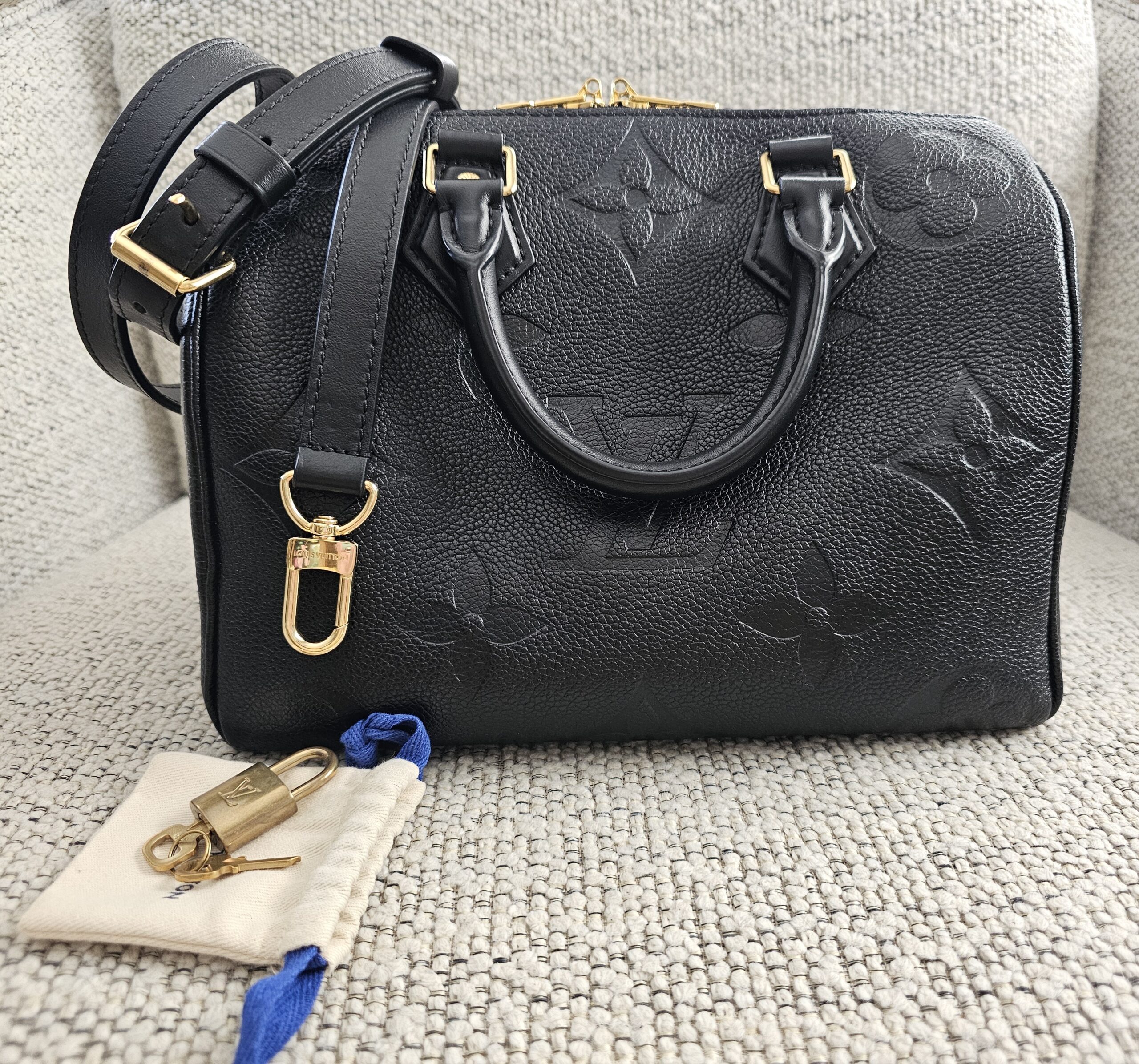 Louis Vuitton Monogram Empreinte Giant Speedy Bandoulière 25 Black - shown with its strap, lock, keys and dust pouch