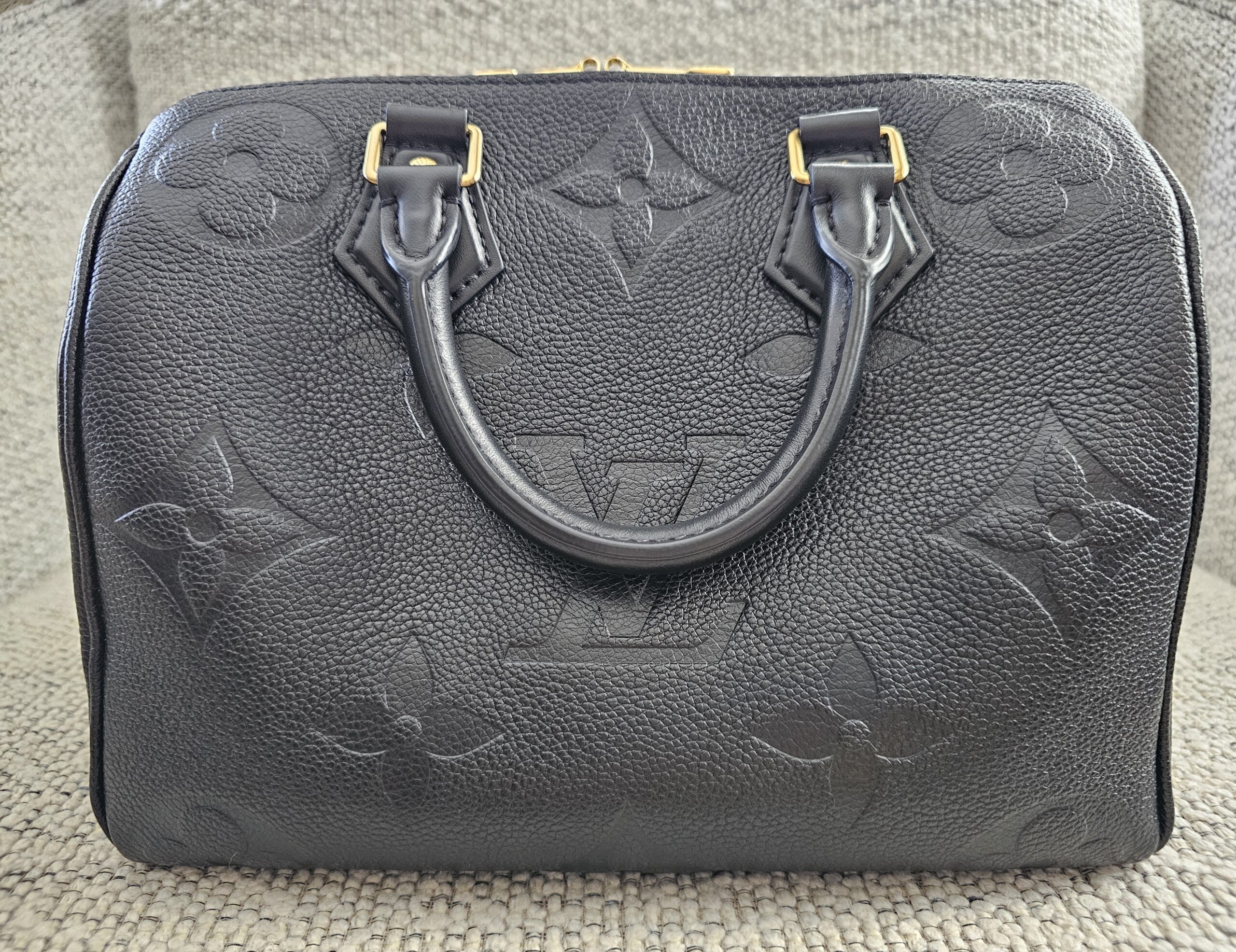 Front view of the black Giant Monogram Empreinte Speedy Bandouliere 25 with gold-tone hardware