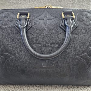 Oversized giant monogram embossing across the front panel of the black Empreinte Speedy Bandouliere 25