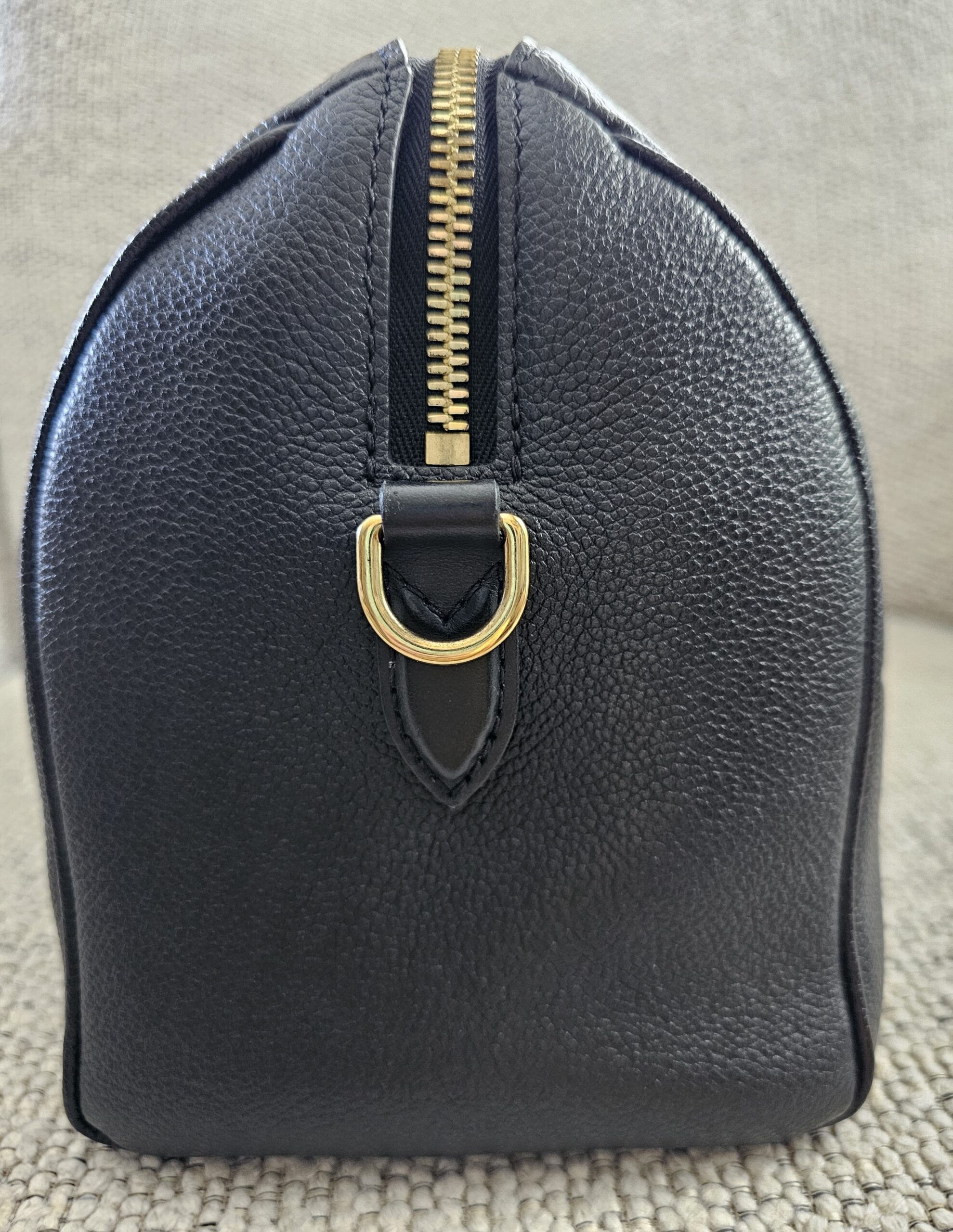 Opposite side of the black Empreinte Speedy Bandouliere 25 showing the second D-ring