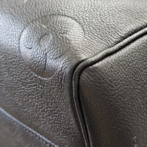 Close-up of a corner on the black Empreinte Speedy Bandouliere 25 showing light edge wear