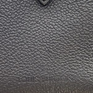 LOUIS VUITTON lettering embossed into the black Monogram Empreinte leather of the Speedy Bandouliere 25