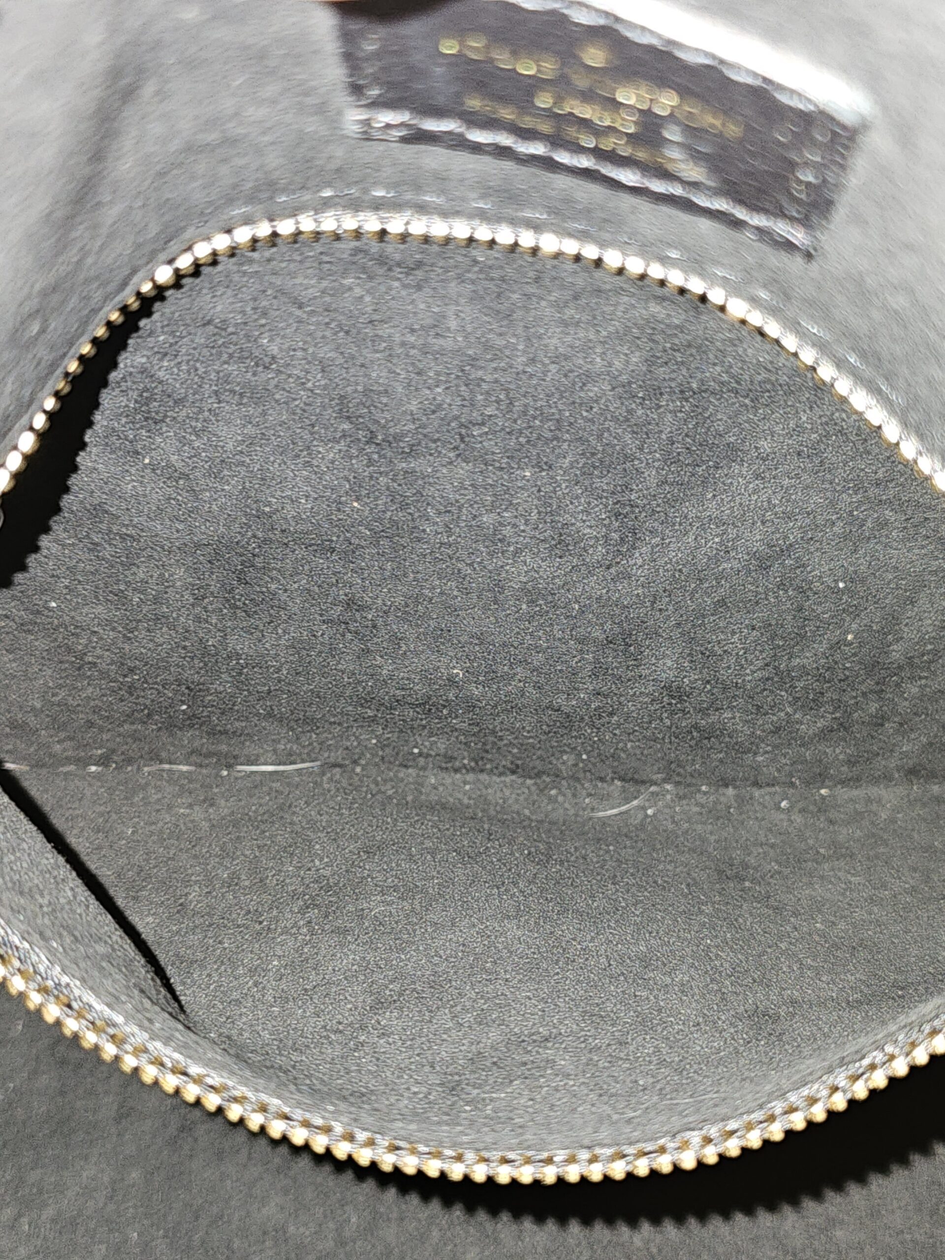 Zip pocket inside the gray lining of the black Empreinte Speedy Bandouliere 25