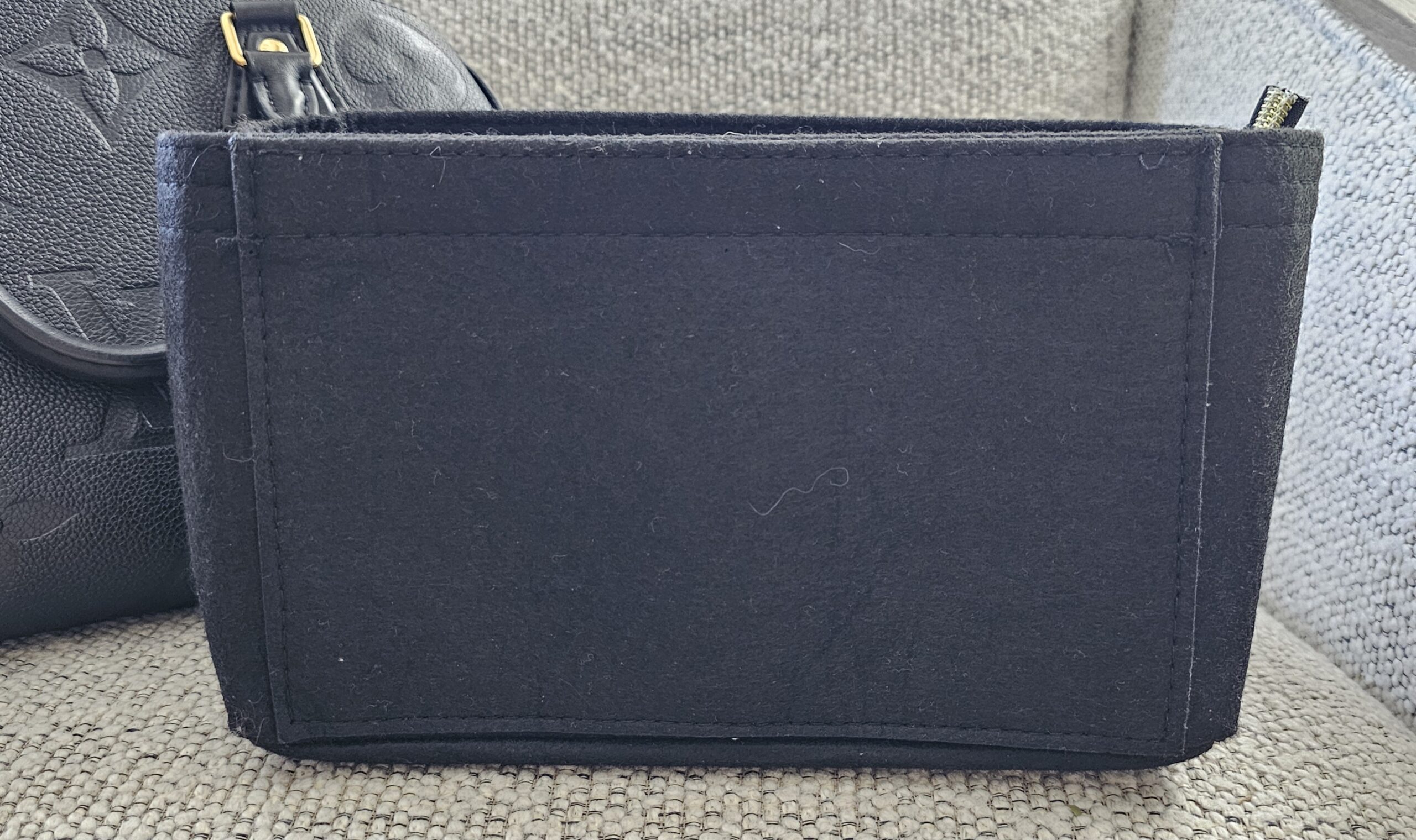 Gray felt organizer insert included with the black Empreinte Speedy Bandouliere 25