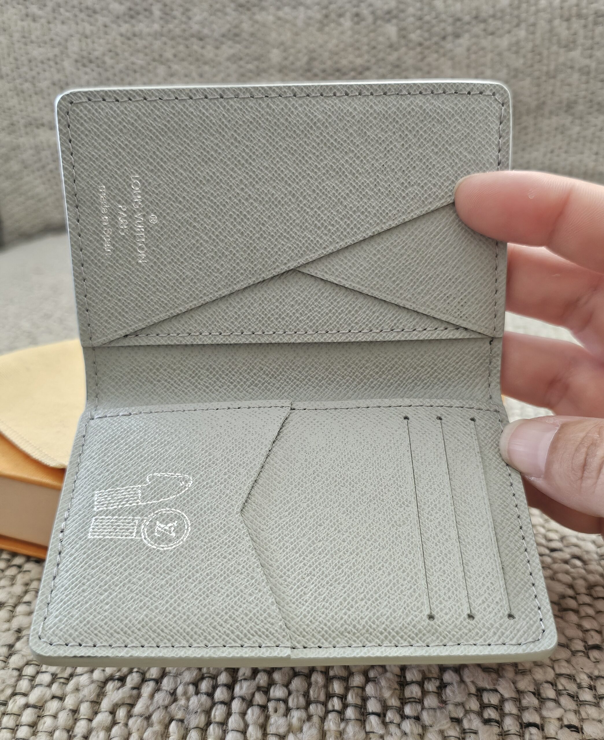 Gray leather interior and card slots of the Louis Vuitton Iridescent Gradient Pocket Organizer
