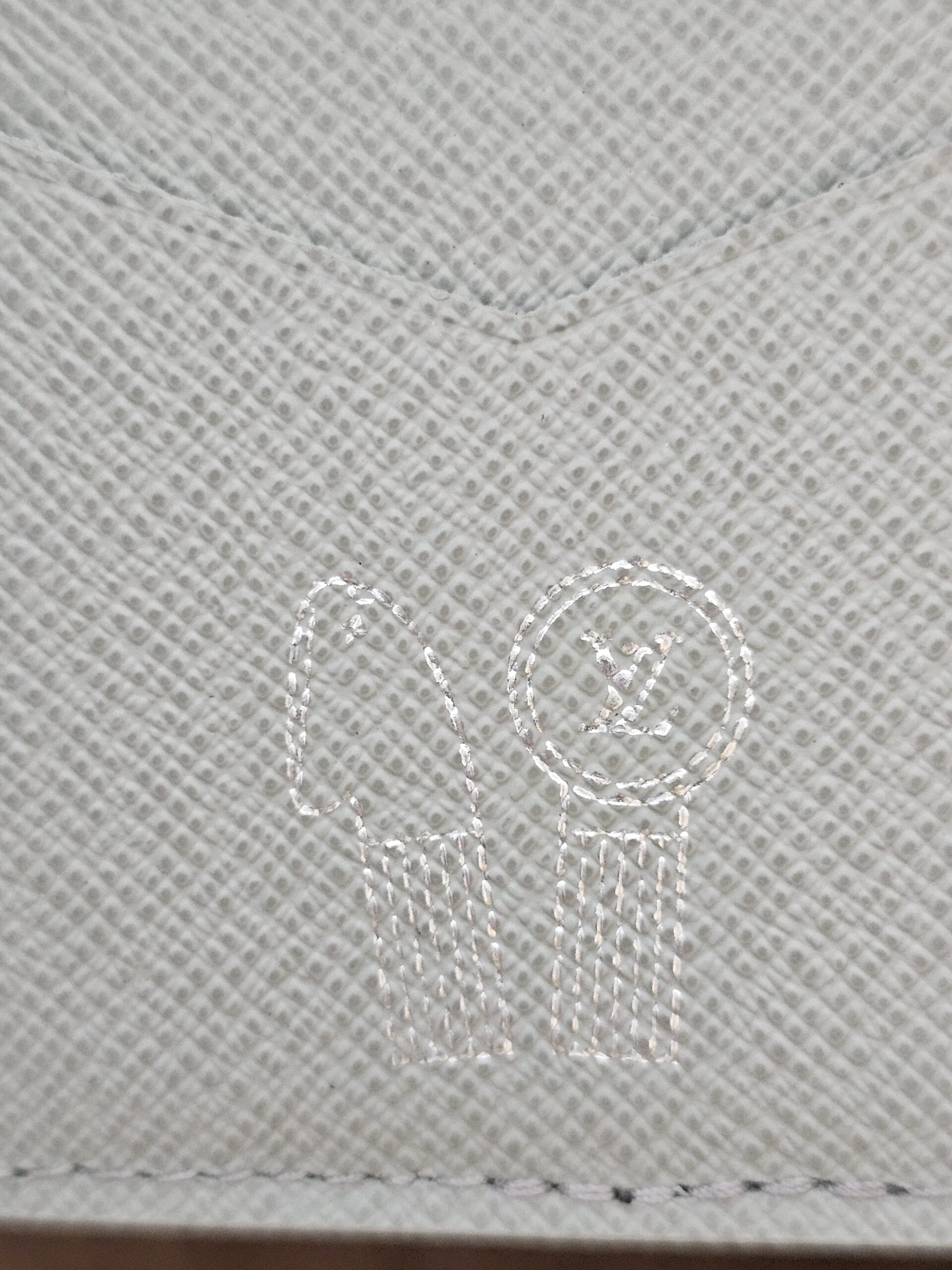 Embossed marking on the gray leather interior of the Louis Vuitton Pocket Organizer