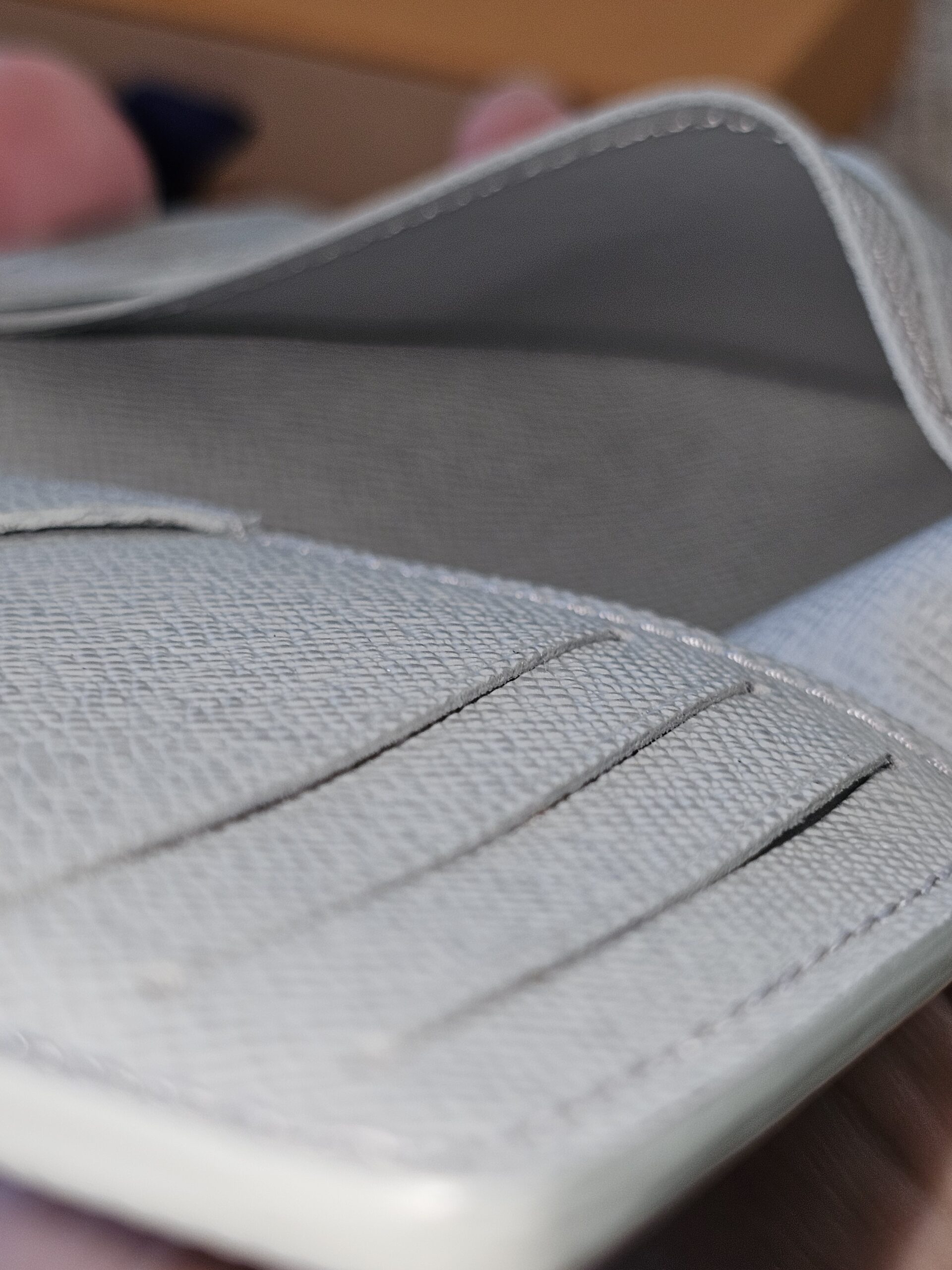 Close-up of the gray leather card slots inside the Louis Vuitton Pocket Organizer