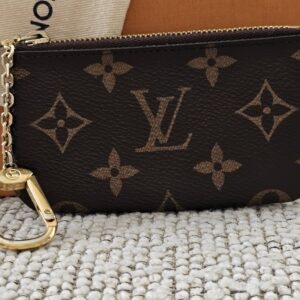 Louis Vuitton Monogram Key Pouch - front view with the gold-tone chain and hook, shown with its box