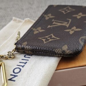 Monogram Key Pouch laid on its dust bag and box