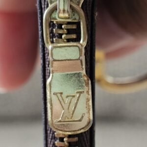 Gold-tone LV zipper pull on the Monogram Key Pouch