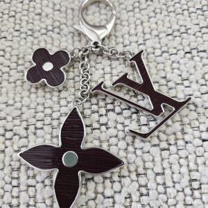 The LV initials, monogram flower and four-petal flower motifs of the plum Epi Fleur de Epi bag charm