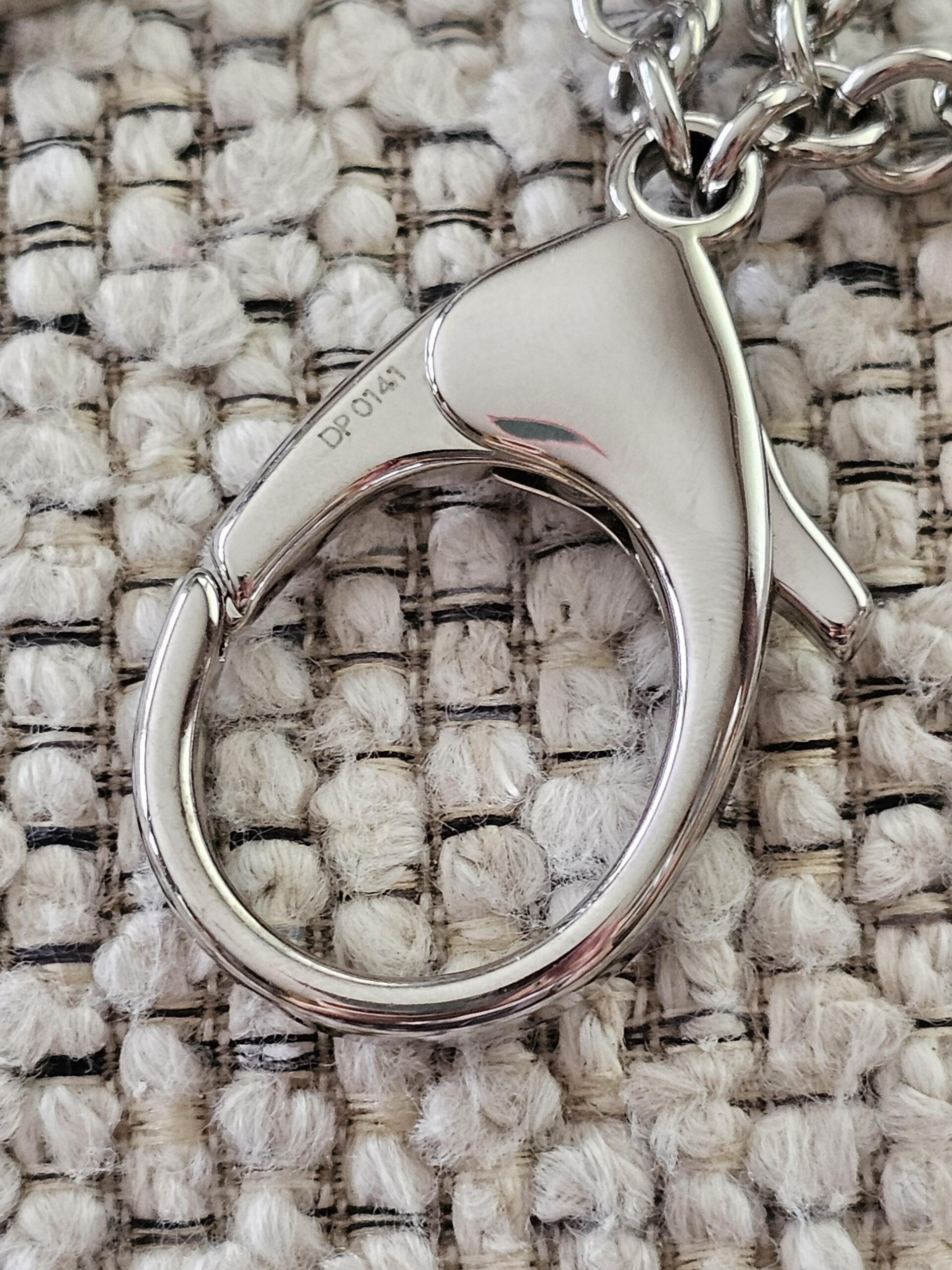 Polished silver-tone lobster clasp on the Louis Vuitton Bijoux Sac Fleur de Epi bag charm