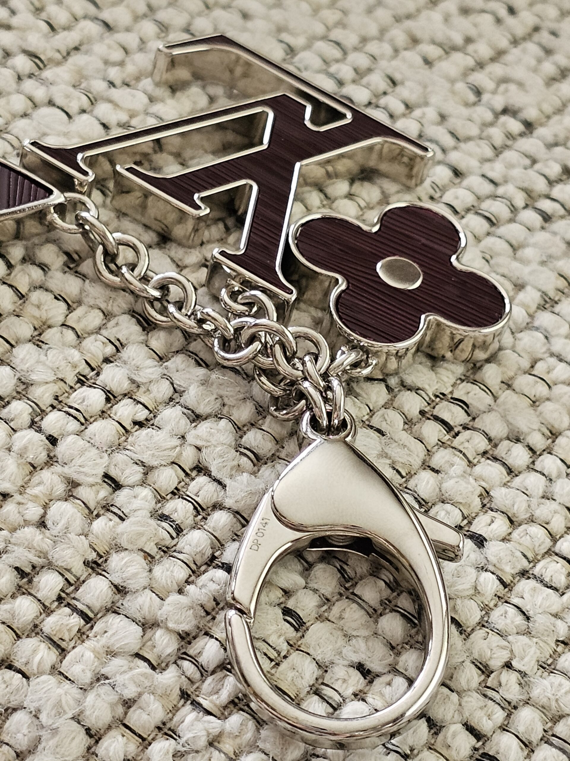 Silver-tone chain linking the plum Epi flower and LV motifs on the Fleur de Epi bag charm