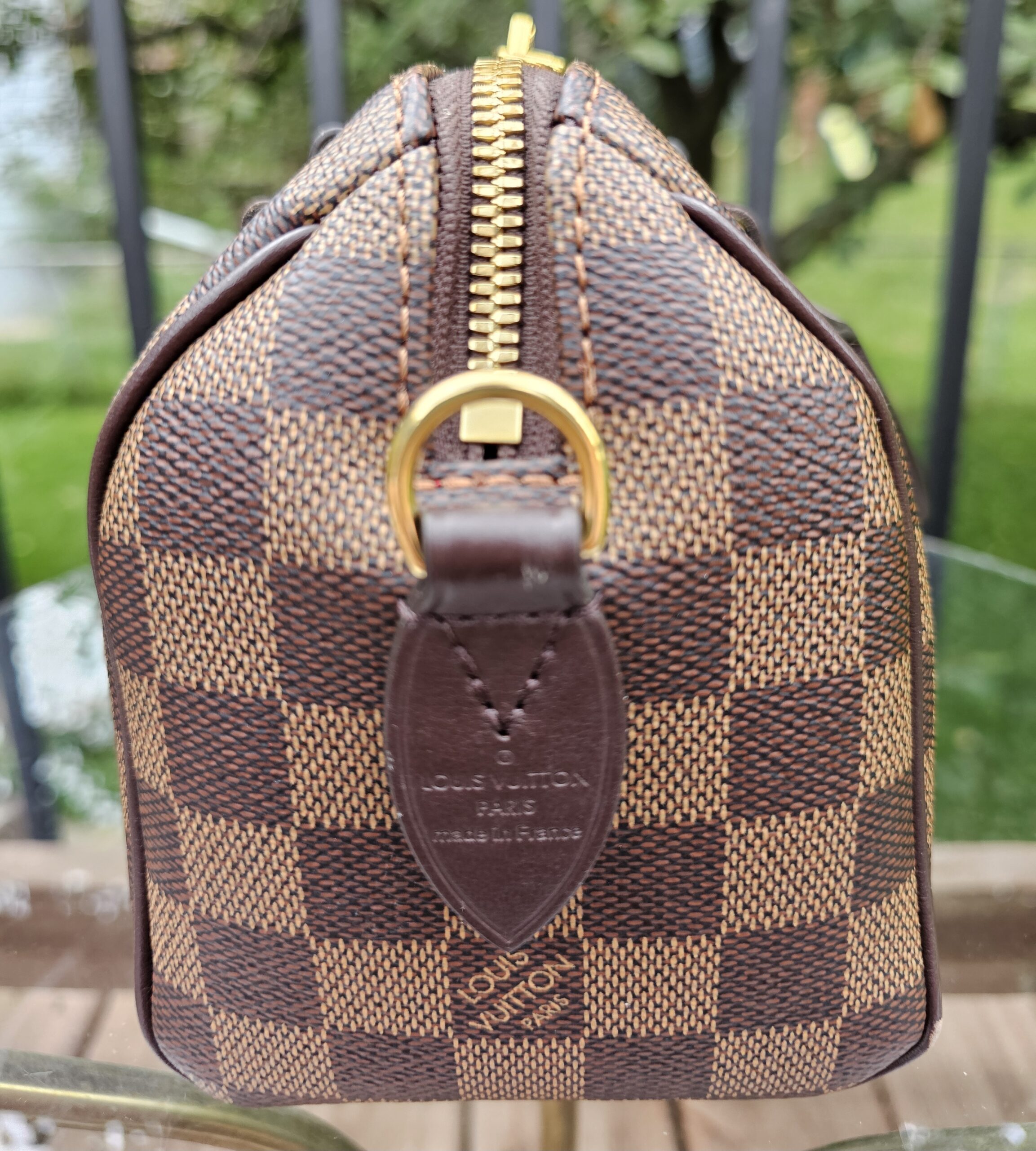 Louis Vuitton Speedy Bandouliere 20 front with the embossed leather name tab visible
