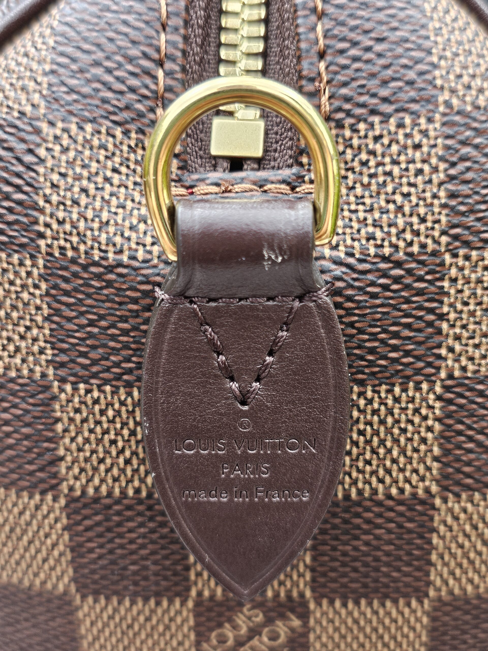LOUIS VUITTON PARIS made in France heat stamp embossed on the leather tab of the Speedy Bandouliere 20