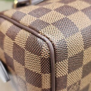 Top corner of the Damier Ebene Speedy Bandouliere 20 with canvas and trim in view