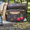 Louis Vuitton x Takashi Murakami Monogram Cerises Mini Bumbag shown with its leather strap and gold-tone chain