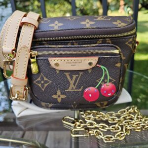 Louis Vuitton x Takashi Murakami Monogram Cerises Mini Bumbag shown with its leather strap and gold-tone chain