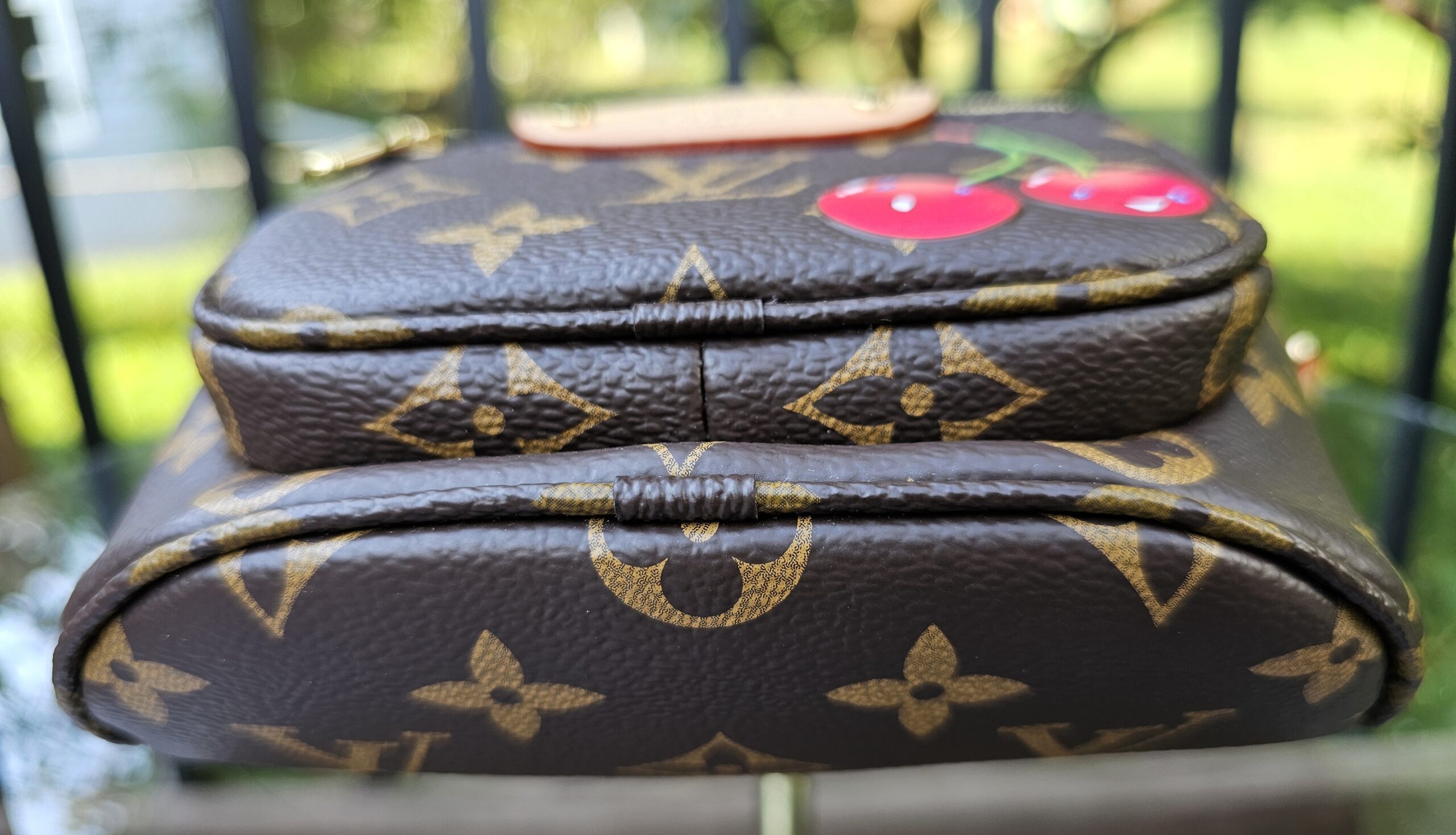 Top view of the Monogram Cerises Mini Bumbag with the cherry motif visible