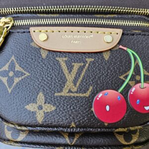 Close-up of the Takashi Murakami smiling Cerises cherry motif on the Monogram Mini Bumbag