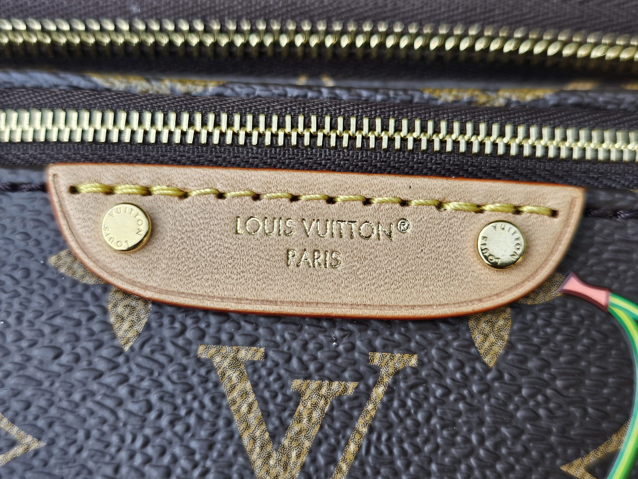 LOUIS VUITTON PARIS stamped vachetta leather name tag on the Cerises Mini Bumbag