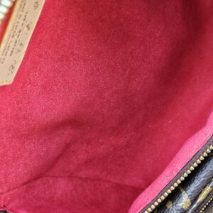 Red microfiber lining inside the Louis Vuitton Cerises Mini Bumbag