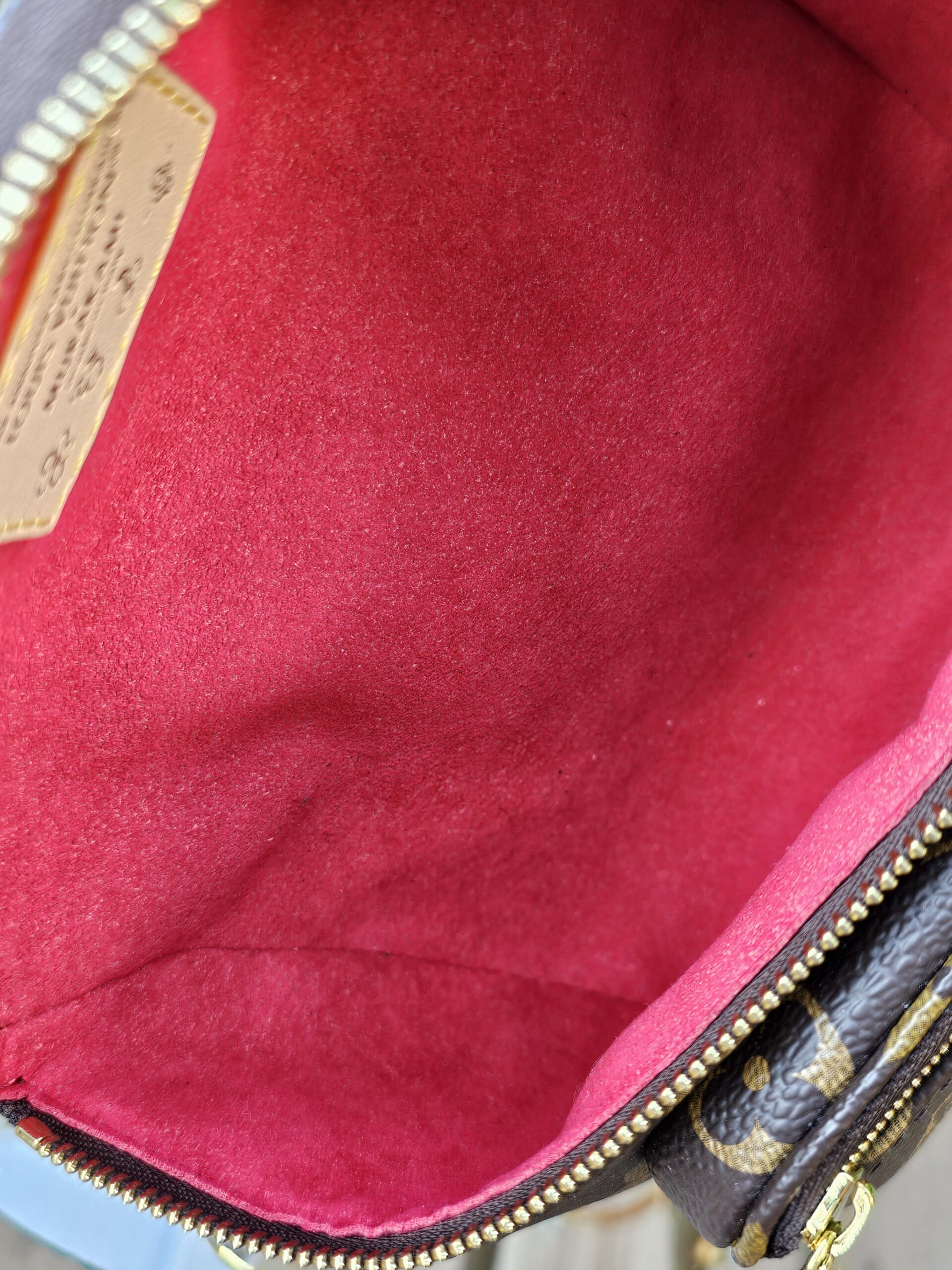 Red microfiber lining inside the Louis Vuitton Cerises Mini Bumbag